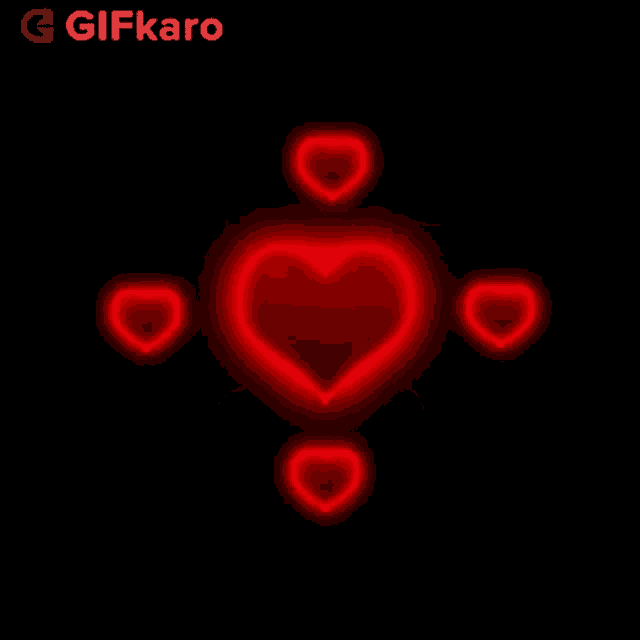a glowing red heart is surrounded by four smaller hearts on a black background .