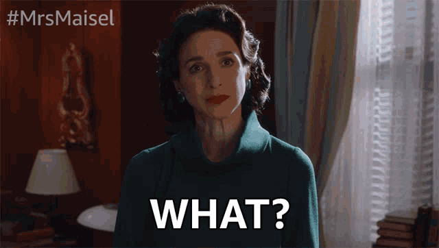a woman in a green sweater says what in front of a window