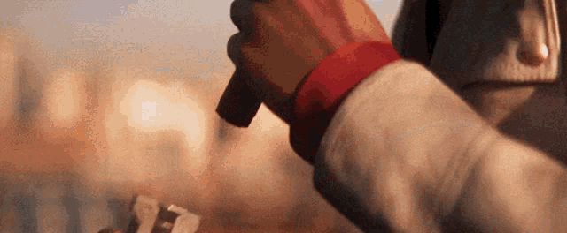 a close up of a person holding a gun in their hands .