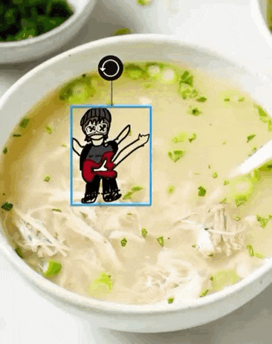 a bowl of soup with a drawing of a man with a guitar