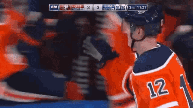 a hockey player with the number 12 on the back of his shirt