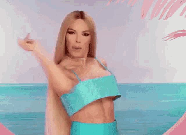 a woman with long blonde hair wearing a blue bikini top