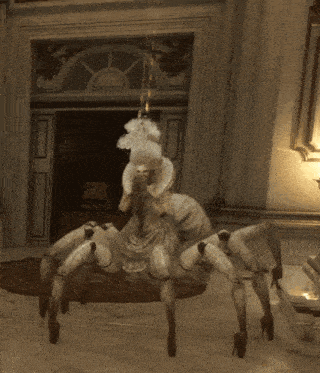 a statue of a woman in a white dress is hanging from the ceiling