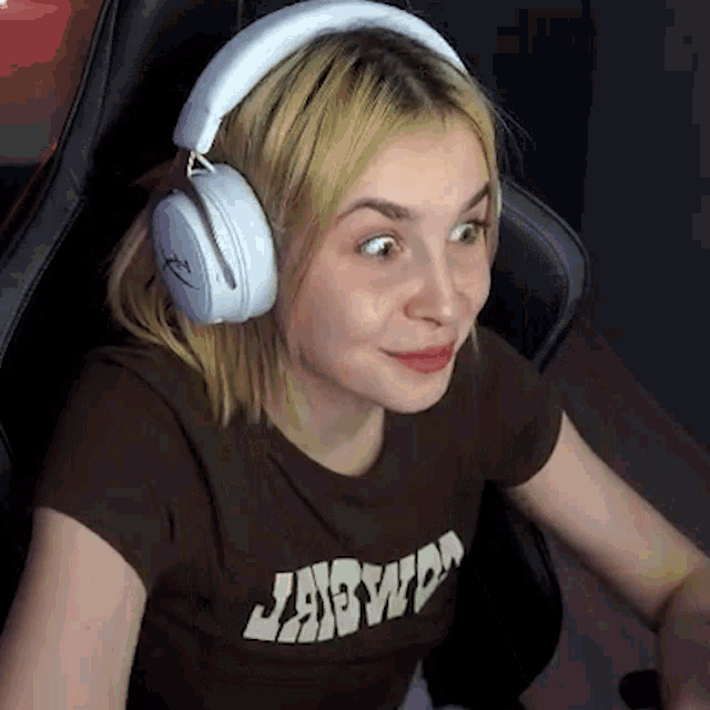 a woman wearing headphones and a t-shirt that says jadwd