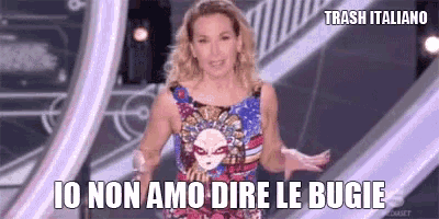 a woman in a colorful dress is standing on a stage with her arms outstretched and says trash italiano .