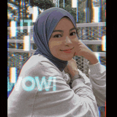 a woman wearing a hijab with the word wow written on the back