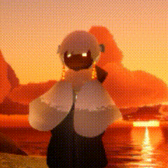 a stuffed animal is standing in front of a sunset in a desert .