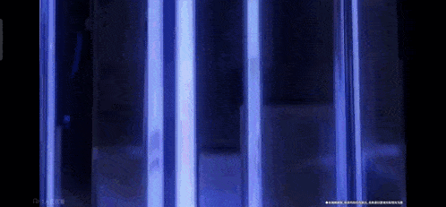 a close up of a blue light behind a glass wall .