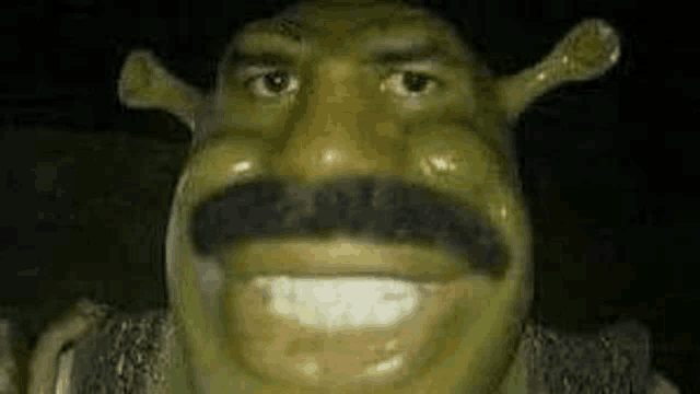 a close up of a shrek statue with a mustache .