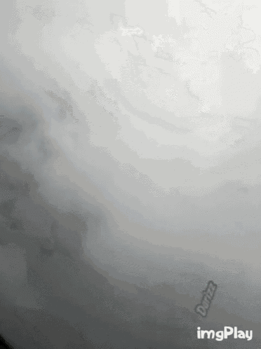 a picture of a cloudy sky with a green sticker that says duty