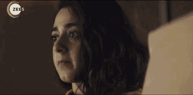 a close up of a woman 's face with the words zee5 on the bottom