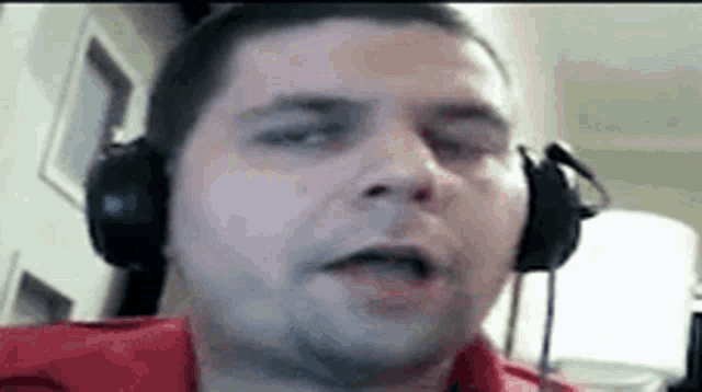 a man wearing headphones is looking at the camera .