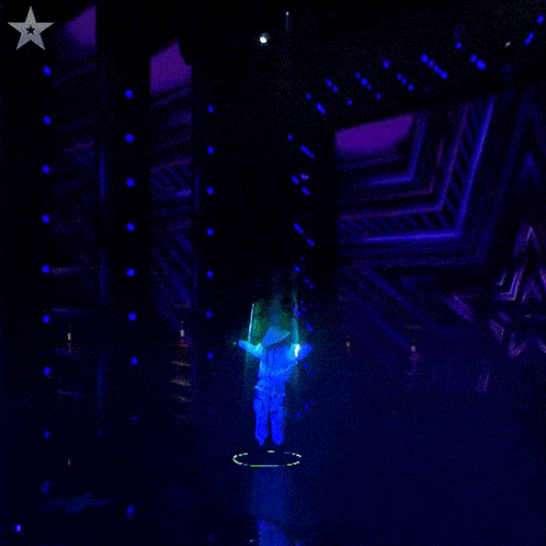 a man in a bee suit is hanging from a rope in a dark room