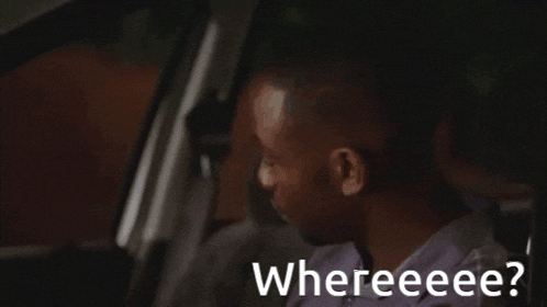a man sitting in a car with the words " whereeee " on the bottom