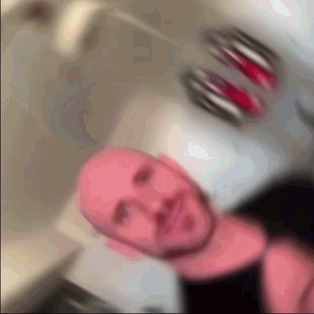 a blurry picture of a man 's face with a red head