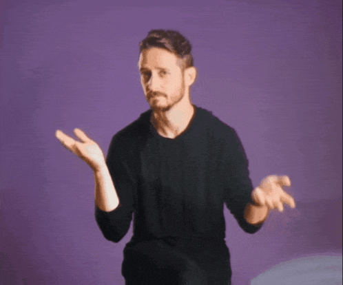 a man in a black shirt is standing in front of a purple background with his hands outstretched