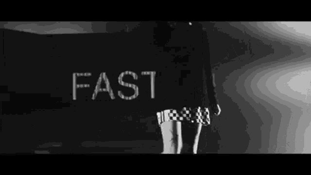 a woman is standing in front of a sign that says fast