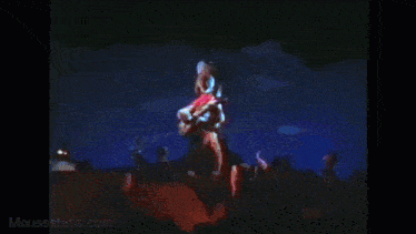 a video of mickey mouse playing a guitar with mousesteps.com in the corner