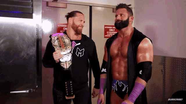 two wrestlers are standing in front of a door that says authorized only on it