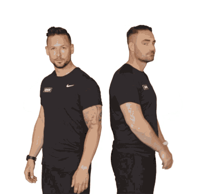a man wearing a nike shirt stands next to another man