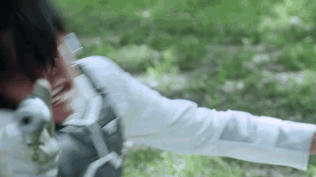 a blurry picture of a person holding a gun in their hand .