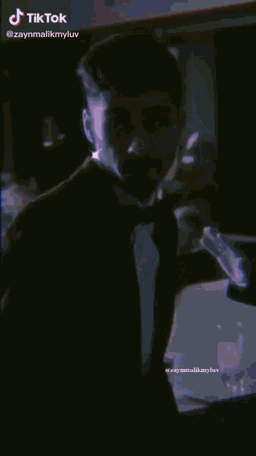 a close up of a man wearing glasses and a hat with a tik tok watermark