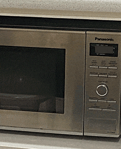 a stainless steel panasonic microwave oven is sitting on a counter
