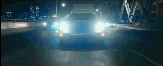 a car is driving down a highway at night and the license plate says ' toyota ' on it