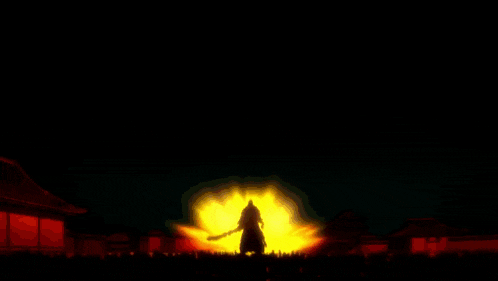 a silhouette of a person standing in front of a large fire