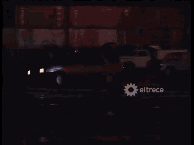a car is driving down a road at night with eltrece written on the bottom