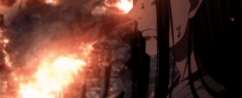 a girl with long black hair is standing in front of a fire