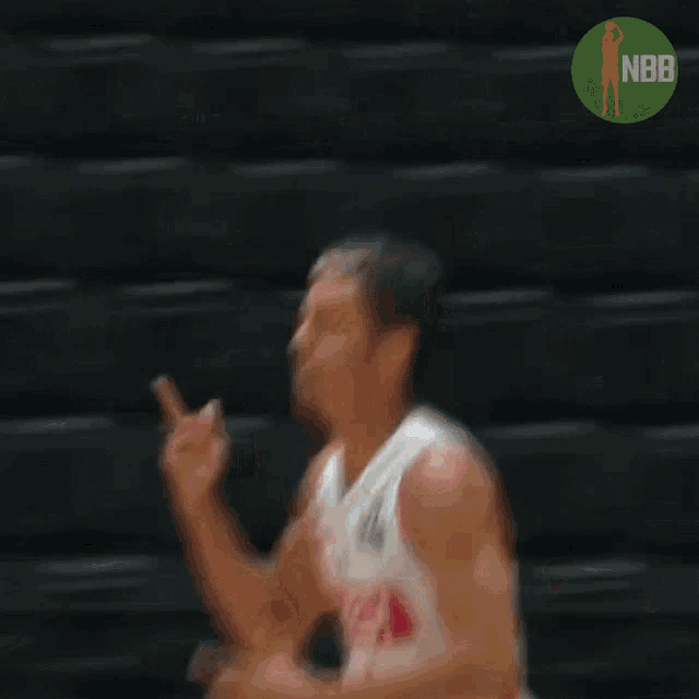 a blurry image of a basketball player with the nbb logo in the background