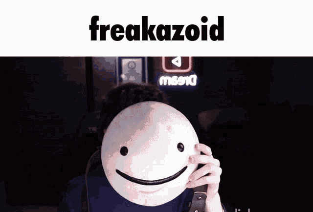 a man wearing a mask with a smiley face and the word freakazoid above him