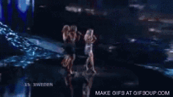 three women singing on a stage with sweden written on the bottom of the screen