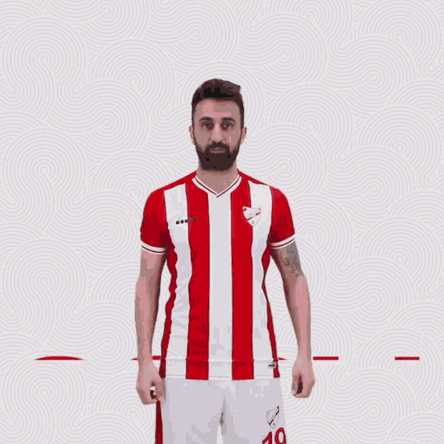 a man in a red and white striped shirt giving a thumbs up in front of the word goal