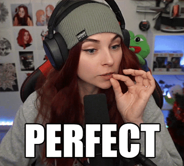 a woman wearing headphones and a beanie with the word perfect on it