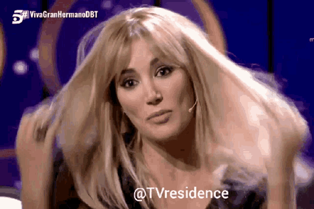 a woman 's hair is blowing in the wind and the words @tvresidence are visible