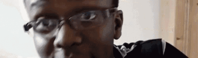 a close up of a man wearing glasses .