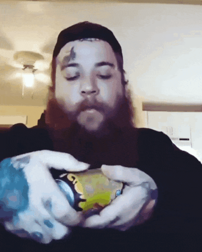 a man with a beard is holding a can that says gatorade