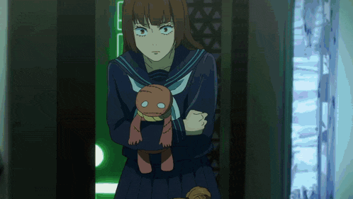 a girl in a school uniform is holding a stuffed animal in her arms