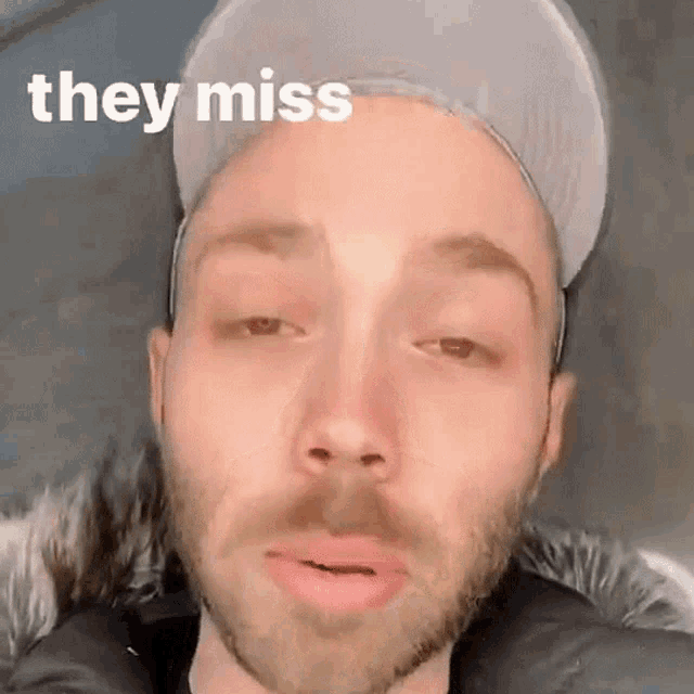 a close up of a man 's face with the words " they miss " behind him