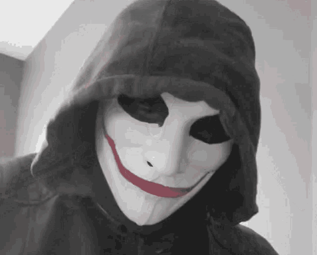 a man wearing a hooded jacket and a white mask with red lips