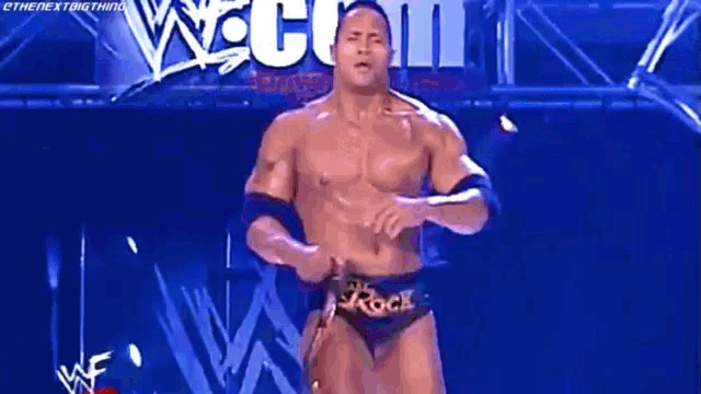a man in a wrestling outfit is standing in front of a sign that says wrestlemania on it .
