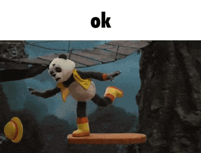 a panda bear is standing on a plank with the word ok above him