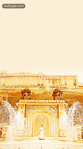 a woman stands in front of a large building with a fountain in front of it and the words kulfyapp.com on the bottom