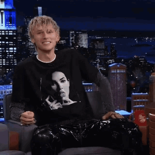a man wearing a black shirt with a woman 's face on it