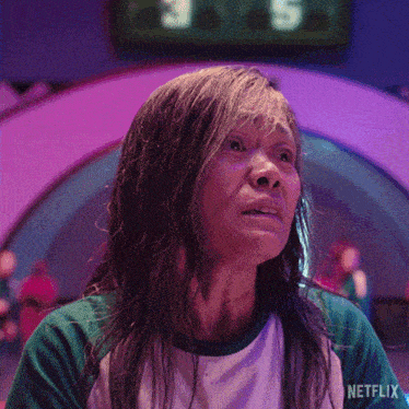 a woman with wet hair is wearing a green and white shirt that says netflix