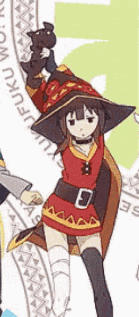 a girl in a witch costume is holding a cat in her hand