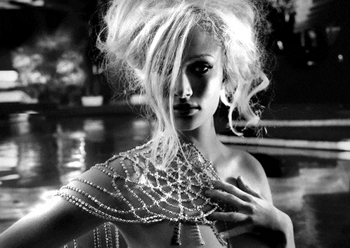 a black and white photo of a woman wearing a choker