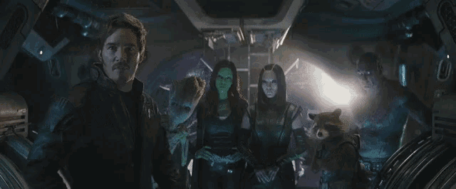 a group of people are standing next to each other in a room .